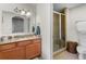 Bathroom featuring granite counters, wood cabinets and a tiled shower with glass door at 7512 Seven Eagles Way # 7512, Reunion, FL 34747