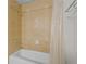 Bathroom shower and tub featuring decorative tile and a shower curtain at 7512 Seven Eagles Way # 7512, Reunion, FL 34747