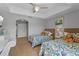 Bedroom with twin beds, ceiling fan, and view of an arched entry at 7512 Seven Eagles Way # 7512, Reunion, FL 34747