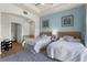 Bedroom with blue accent wall leads to Primary bath at 7512 Seven Eagles Way # 7512, Reunion, FL 34747