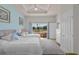 Bedroom featuring 2 beds, tray ceiling, large window, and wood floors at 7512 Seven Eagles Way # 7512, Reunion, FL 34747