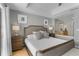 Comfortable bedroom showcasing a king-size bed, side tables with lamps, and a glimpse into a bathroom with granite countertops at 7512 Seven Eagles Way # 7512, Reunion, FL 34747