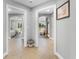 Hallway view showcasing tile flooring and arched doorways leading to bedrooms and a sunlit living area with serene views at 7512 Seven Eagles Way # 7512, Reunion, FL 34747
