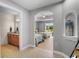 Hallway with a view into bedroom featuring twin beds and to a vanity area; natural light and calming colors enhance the space at 7512 Seven Eagles Way # 7512, Reunion, FL 34747