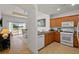 Kitchen open to the dining and living room boasts granite counters and white appliances at 7512 Seven Eagles Way # 7512, Reunion, FL 34747