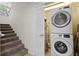 Laundry room with stacked washer and dryer and nearby staircase at 7512 Seven Eagles Way # 7512, Reunion, FL 34747