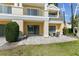 Outdoor patio with stylish pavers, seating, and beautiful landscaping with mature trees at 7512 Seven Eagles Way # 7512, Reunion, FL 34747