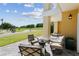 Patio with outdoor seating overlooking a lawn and golf course at 7512 Seven Eagles Way # 7512, Reunion, FL 34747
