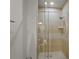 Glass-enclosed shower featuring neutral tile surround at 7512 Seven Eagles Way # 7512, Reunion, FL 34747