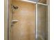Shower stall with tile walls and a glass door at 7512 Seven Eagles Way # 7512, Reunion, FL 34747