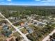 Overhead view of a residential community with tree coverage, multiple houses, and connecting roads at 1139 9Th Ave, Deland, FL 32724