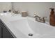 Close-up on bathroom vanity with double sinks, silver faucets, and decorative toiletries at 1139 9Th Ave, Deland, FL 32724