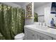Stylish bathroom with a unique butterfly-themed shower curtain, white vanity, and chrome faucet at 1139 9Th Ave, Deland, FL 32724