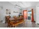 Open dining area featuring a modern table, bench, stylish light fixture, and patio access at 1139 9Th Ave, Deland, FL 32724