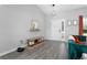 Bright entryway featuring stylish wood flooring, a decorative mirror, and a cozy bench at 1139 9Th Ave, Deland, FL 32724