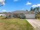 Charming single-story home with a well-manicured lawn and a two-car garage at 1139 9Th Ave, Deland, FL 32724