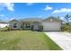 Charming single-story home with well-manicured lawn, a two-car garage, and inviting front entrance at 1139 9Th Ave, Deland, FL 32724