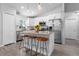 Well-lit kitchen featuring white cabinets, stainless steel appliances, and a center island with seating at 1139 9Th Ave, Deland, FL 32724