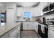 Modern kitchen with white cabinets, granite countertops, and stainless steel appliances at 1139 9Th Ave, Deland, FL 32724