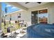 Covered patio with a hot tub, seating area, and sliding glass doors to the interior at 1139 9Th Ave, Deland, FL 32724