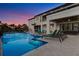 Elegant outdoor living space with a pool, lounge chairs, and a covered patio area at 1148 Grand Traverse Pkwy, Reunion, FL 34747