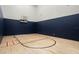 Indoor basketball court with hardwood floor, a hoop, and painted blue wall padding at 1148 Grand Traverse Pkwy, Reunion, FL 34747