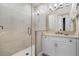 Bathroom with a glass shower door, vanity, and decorative wall tiles at 1148 Grand Traverse Pkwy, Reunion, FL 34747
