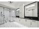 Elegant bathroom with double vanity, black countertops, walk-in shower and stylish geometric tile floor at 1148 Grand Traverse Pkwy, Reunion, FL 34747