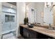 Modern bathroom with a walk-in shower, vessel sink, stylish vanity, and a large mirror at 1148 Grand Traverse Pkwy, Reunion, FL 34747