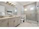 Bathroom featuring a glass shower, neutral tile, vanity, and great lighting at 1148 Grand Traverse Pkwy, Reunion, FL 34747