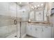 This bathroom features a glass shower enclosure, large mirror, and custom vanity at 1148 Grand Traverse Pkwy, Reunion, FL 34747
