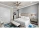 Spacious bedroom with white bedding, bench, and a large area rug at 1148 Grand Traverse Pkwy, Reunion, FL 34747