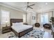 Spacious primary bedroom with custom lighting, a sitting area, and light colored flooring at 1148 Grand Traverse Pkwy, Reunion, FL 34747