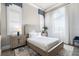 Bright bedroom with large windows, shutters, neutral decor, and stylish furnishings at 1148 Grand Traverse Pkwy, Reunion, FL 34747