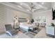 Luxurious bedroom with tray ceilings, patterned wallpaper, and a comfortable sitting area at 1148 Grand Traverse Pkwy, Reunion, FL 34747