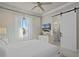 Bright bedroom features a sliding barn door to the bathroom and a ceiling fan at 1148 Grand Traverse Pkwy, Reunion, FL 34747