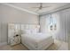 Bright bedroom features a large window, white accents, and luxurious bedding, creating a serene retreat at 1148 Grand Traverse Pkwy, Reunion, FL 34747