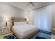 Bright bedroom with a large bed, accent rug, nightstands, and window at 1148 Grand Traverse Pkwy, Reunion, FL 34747