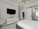 Bedroom with white dresser, TV, sliding barn door access to the bathroom at 1148 Grand Traverse Pkwy, Reunion, FL 34747