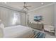 Bright bedroom with white furniture, large window, and light colored flooring at 1148 Grand Traverse Pkwy, Reunion, FL 34747