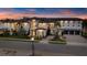 Stunning exterior view of a luxury home with manicured landscaping and a paver driveway at sunset at 1148 Grand Traverse Pkwy, Reunion, FL 34747