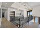 Open hallway with decorative railing, shelving, and natural light, creating a seamless flow at 1148 Grand Traverse Pkwy, Reunion, FL 34747