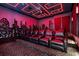 Immersive home theater with comfortable seating, a large screen, and dramatic lighting for an enhanced viewing experience at 1148 Grand Traverse Pkwy, Reunion, FL 34747