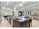 Bright, open-concept kitchen with a large island, stainless steel appliances, and modern pendant lighting at 1148 Grand Traverse Pkwy, Reunion, FL 34747