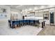 Stylish kitchen featuring a large island with seating, modern lighting, and stainless steel appliances at 1148 Grand Traverse Pkwy, Reunion, FL 34747