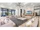 Expansive living room featuring a stone fireplace, modern ceiling fan, and plenty of seating at 1148 Grand Traverse Pkwy, Reunion, FL 34747