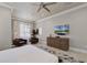 Bright main bedroom featuring a ceiling fan, TV, armchairs, and geometric tile flooring detail at 1148 Grand Traverse Pkwy, Reunion, FL 34747