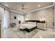Luxurious main bedroom featuring a decorative ceiling, modern furnishings, and a sliding barn door at 1148 Grand Traverse Pkwy, Reunion, FL 34747