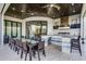 Outdoor kitchen featuring a grill, wood ceiling, outdoor seating area, and stylish tiled counter at 1148 Grand Traverse Pkwy, Reunion, FL 34747