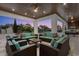 Inviting covered patio with comfortable seating and views of the pool and lush backyard at 1148 Grand Traverse Pkwy, Reunion, FL 34747